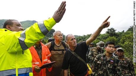 Two British cave-divers (2nd and 3rd-L) with Thai army soldiers and local rescue personnel are seen searching for new openings in the mountain of Khun Nam Nang Non Forest Park in Chiang Rai province on June 28, 2018 during rescue operation for a missing children&#39;s football team and their coach in Tham Luang cave. - A team of US military personnel and British divers joined rescue efforts at a flooded cave in northern Thailand where 12 children and their football coach have been trapped for five days as heavy overnight rains hampered the search. (Photo by Krit PHROMSAKLA NA SAKOLNAKORN / THAI NEWS PIX / AFP)        (Photo credit should read KRIT PHROMSAKLA NA SAKOLNAKORN/AFP/Getty Images)